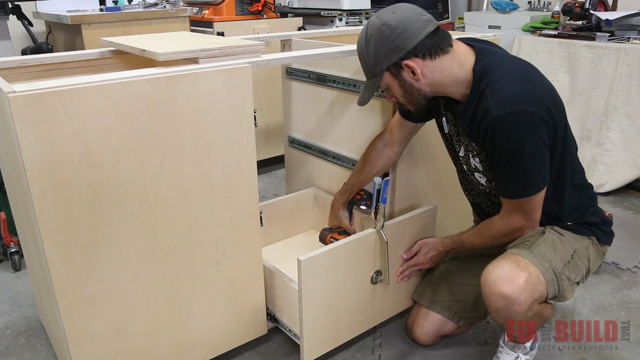 attaching false drawer fronts to the base cabinet drawers