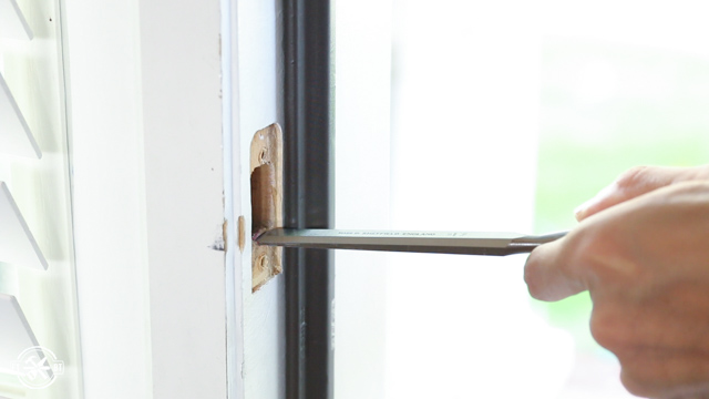 using a chisel to shave down door lock