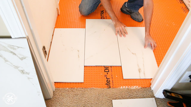 arraigning tiles on bathroom floor