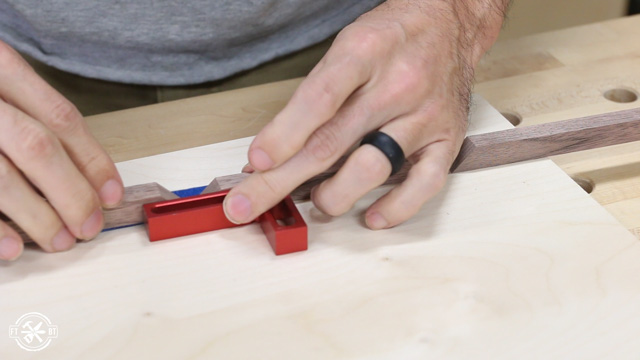 gluing and taping the mitered corners on wood