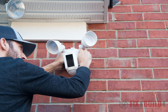 installing a ring floodlight cam on red brick wall