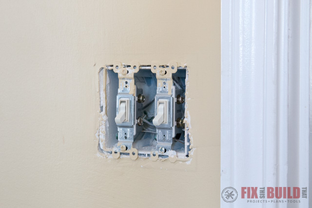 light switches on a yellow wall