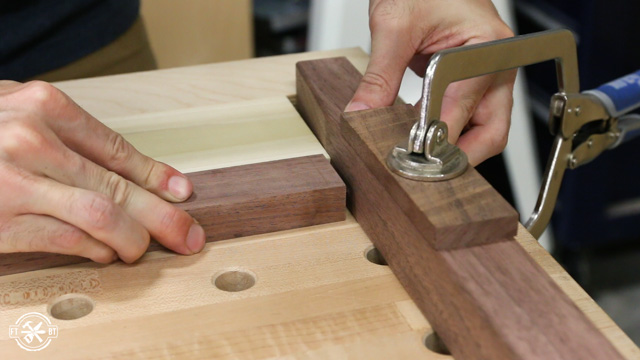 pressing the metal dowels into table legs