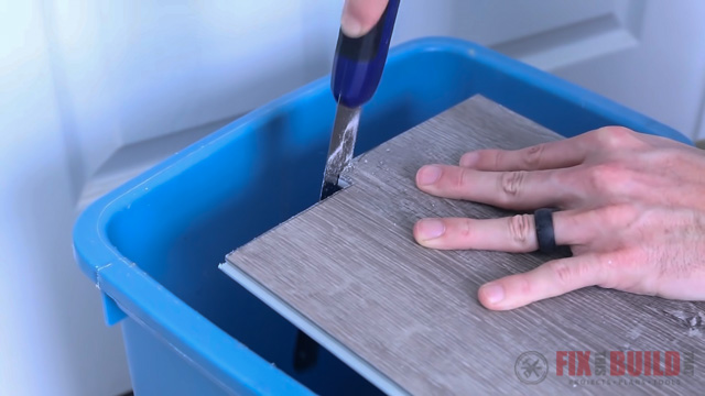 Cutting vinyl plank flooring with handsaw