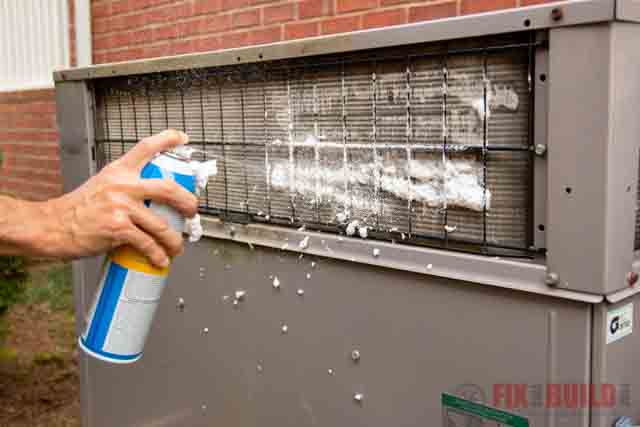 spraying foaming cleaner on HVAC