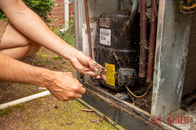 removing debris from inside HVAC unit