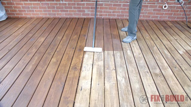 applying stain to deck