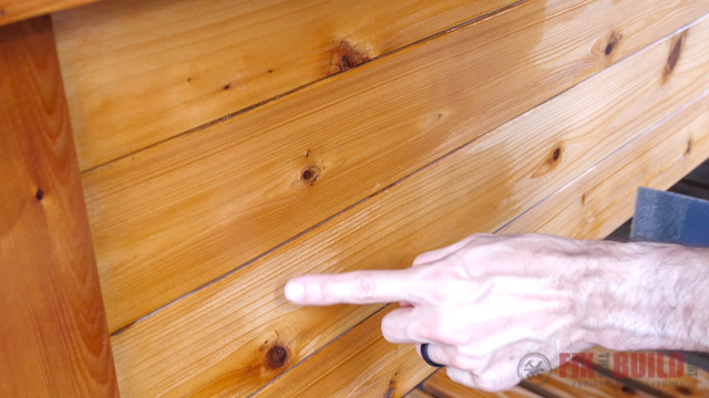 pointing out uneven coverage of varnish on wooden furniture