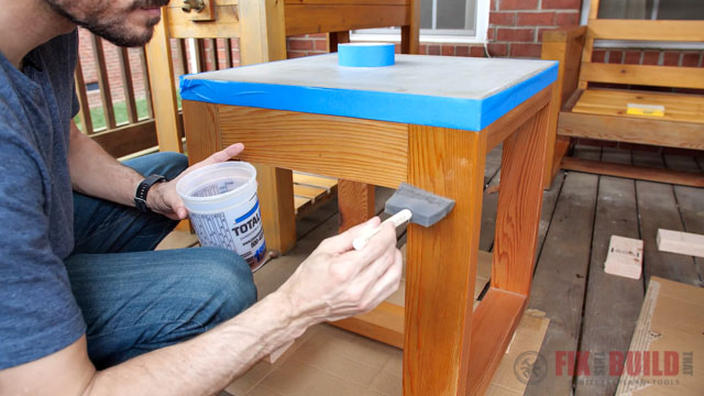 applying varnish to wooden outdoor furniture