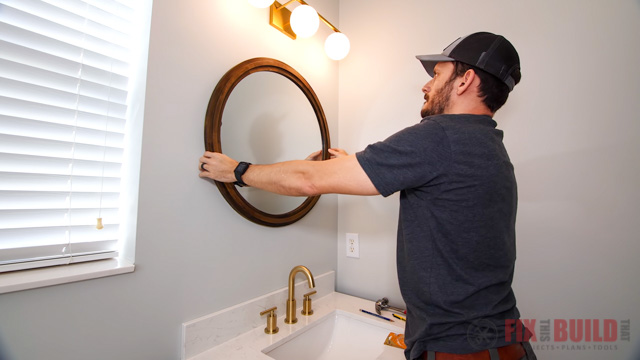 hanging mirror in bathroom