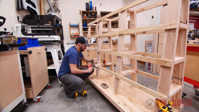 screwing plywood strips to lumber cart