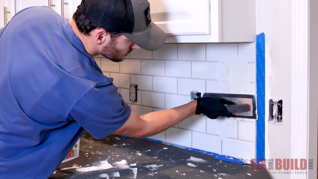 applying grout to tile