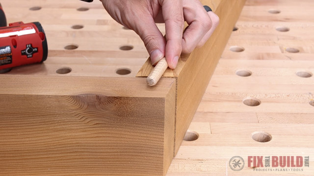 placing dowel on wooden pieces
