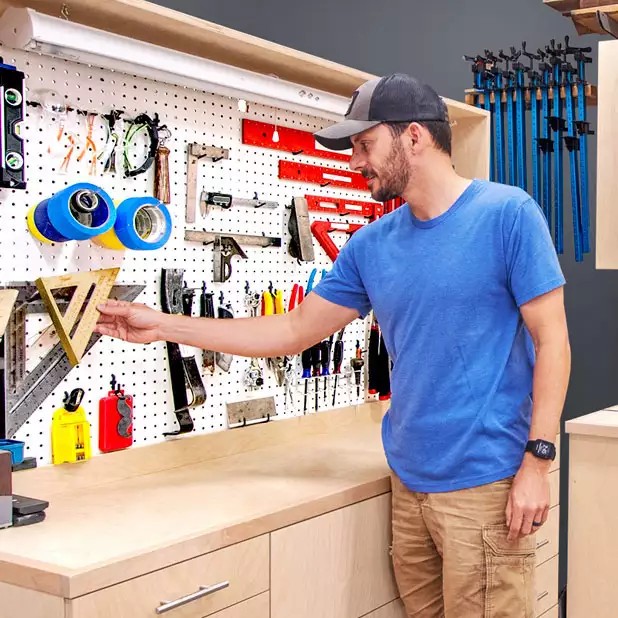Brad looking at tools on pegboard