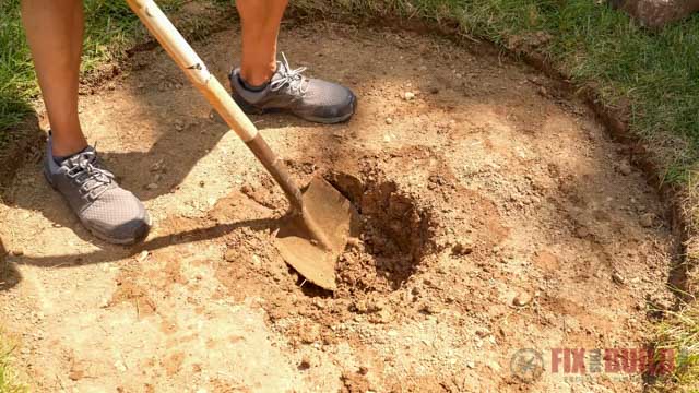 digging a drainage hole in bottom of fire pit 