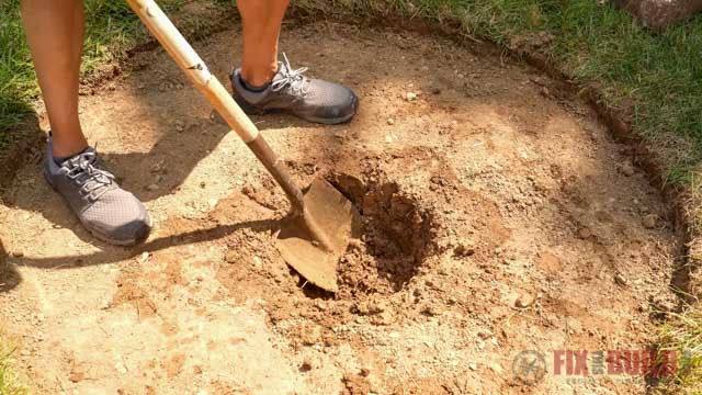 digging a drainage hole in bottom of DIY fire pit