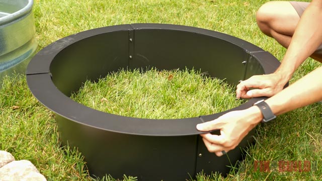 metal fire pit ring sitting on grass