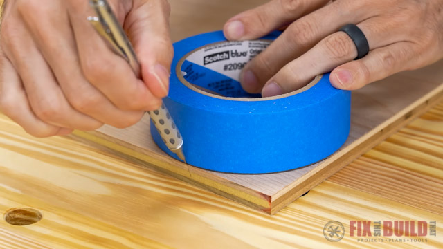 marking curved line on wood with pencil and painters tape