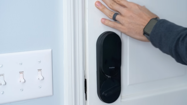 man pushing on closed door to see how much it will move