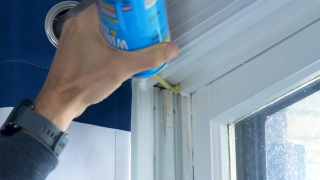 Adding expanding foam to cracks in window frame